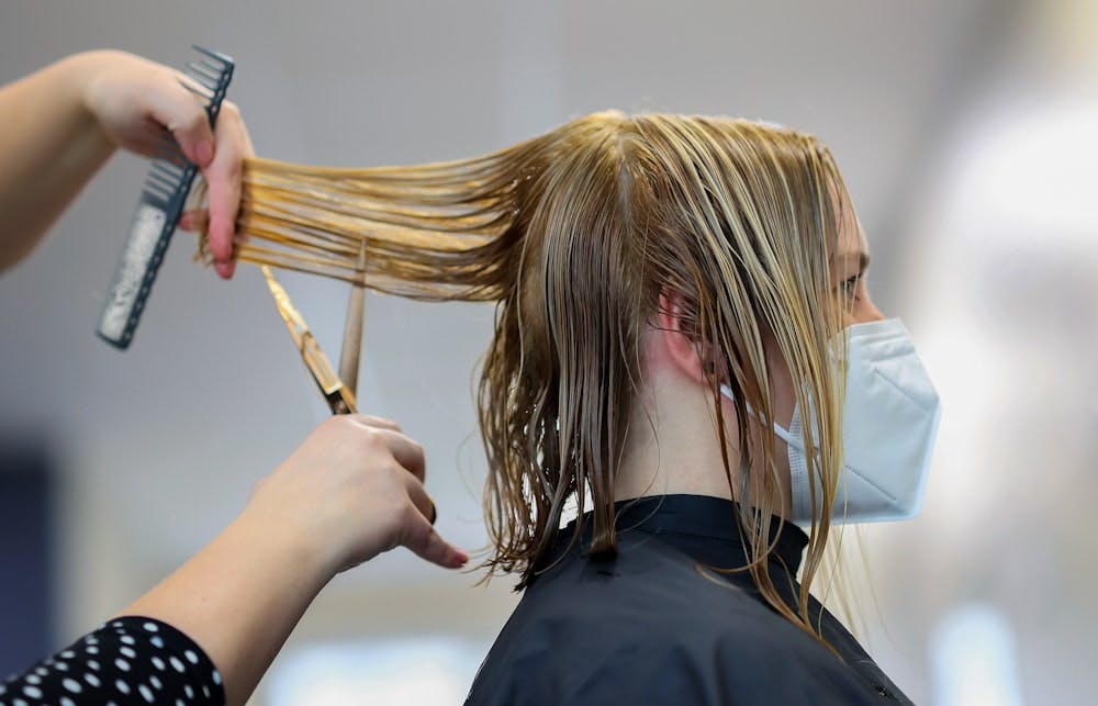 Picture of woman cutting hair.